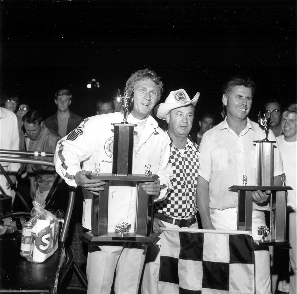 Steve McQueen holding the winners trophy at Ascot Speedway