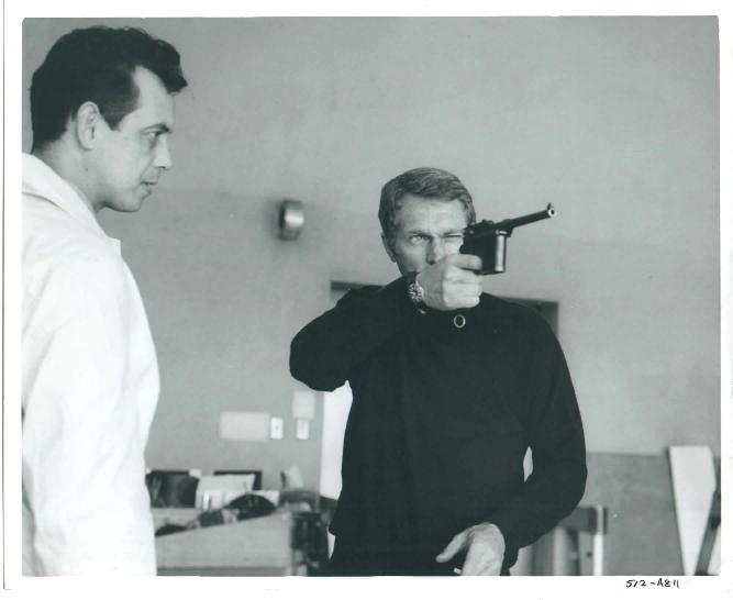 Steve McQueen does a little target practice at the San Francisco police headquarters during filming.