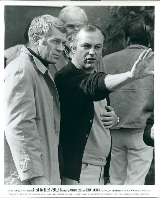 Steve and director Peter Yates discuss a scene.  
Director of photography William Fraker stands directly behind them.