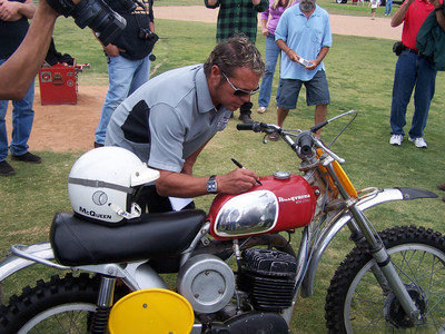 Chad McQueen sighns the Husky's tank