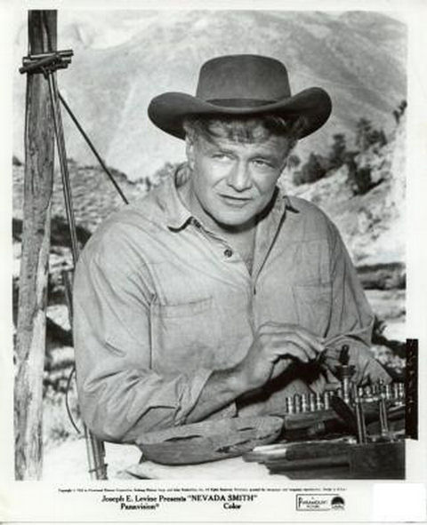 Jonas Cord (Brian Keith) reloading bullet cartridges.