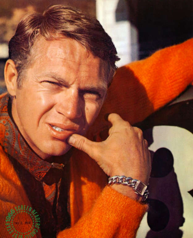 steve mcqueen in an orange sweater