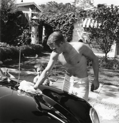 Steve polishing car as young Chad watches