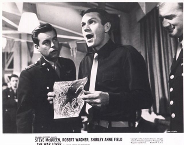 Robert Wagner (as Bo) watches on as Steve McQueen (as Buzz Rickson) holds up a reconnaissance report. 

Buzz exclaims - '10 direct hits!'