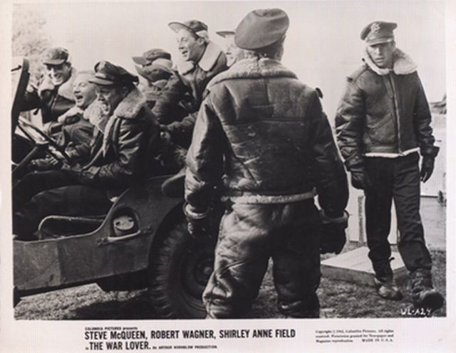 Steve McQueen and crew have fun in a Jeep on the set.